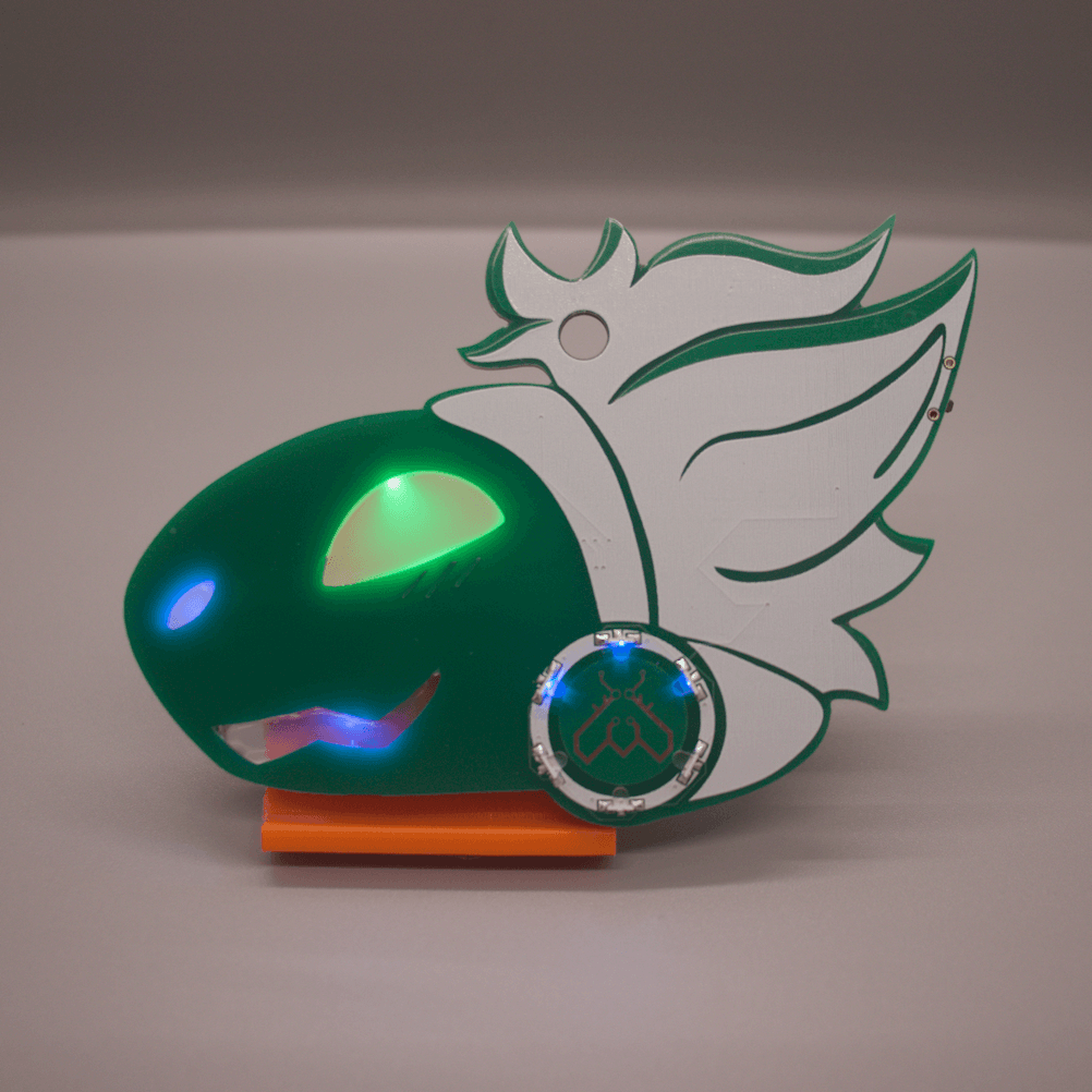 Photo of a green PCB badge in the shape of a protogen's head. They have a happy expression, and their facial features are cutouts in the PCB filled with hot glue. They have white hair, and a circle of LEDs on their cheek with the Lepi Lab logo made of copper in the middle.