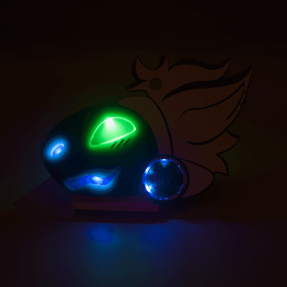 A brightly illuminated PCB badge in a dark environment. The badge is in the shape of a protogen's head. They have a happy expression. The eyes are illuminated green, and the mouth and nose are blue. They also have a circle of blue LEDs on their cheek with a copper Lepi Labs logo in the center. They have white hair.